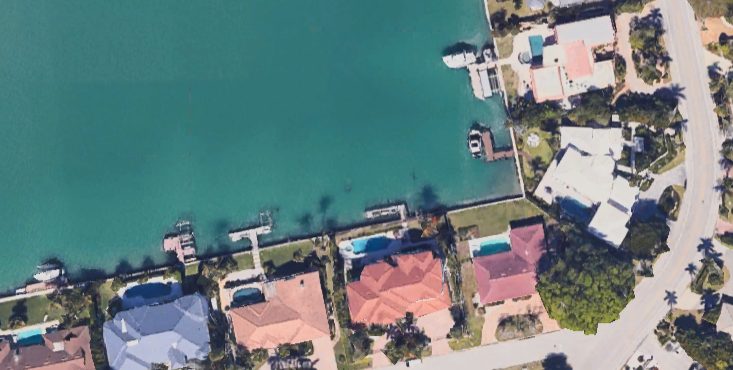 Aerial view of waterfront homes with docks on a Gulf Coast bay