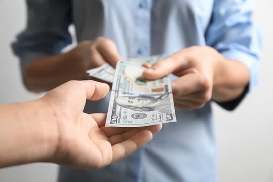 One person handing cash to another